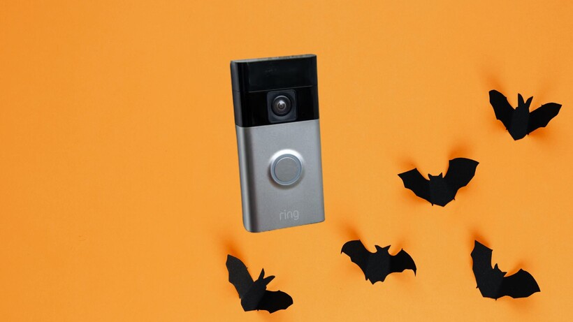A halloween background with bats on it and a ring doorbell